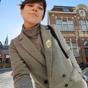 yellow pin on grey coat in groningen