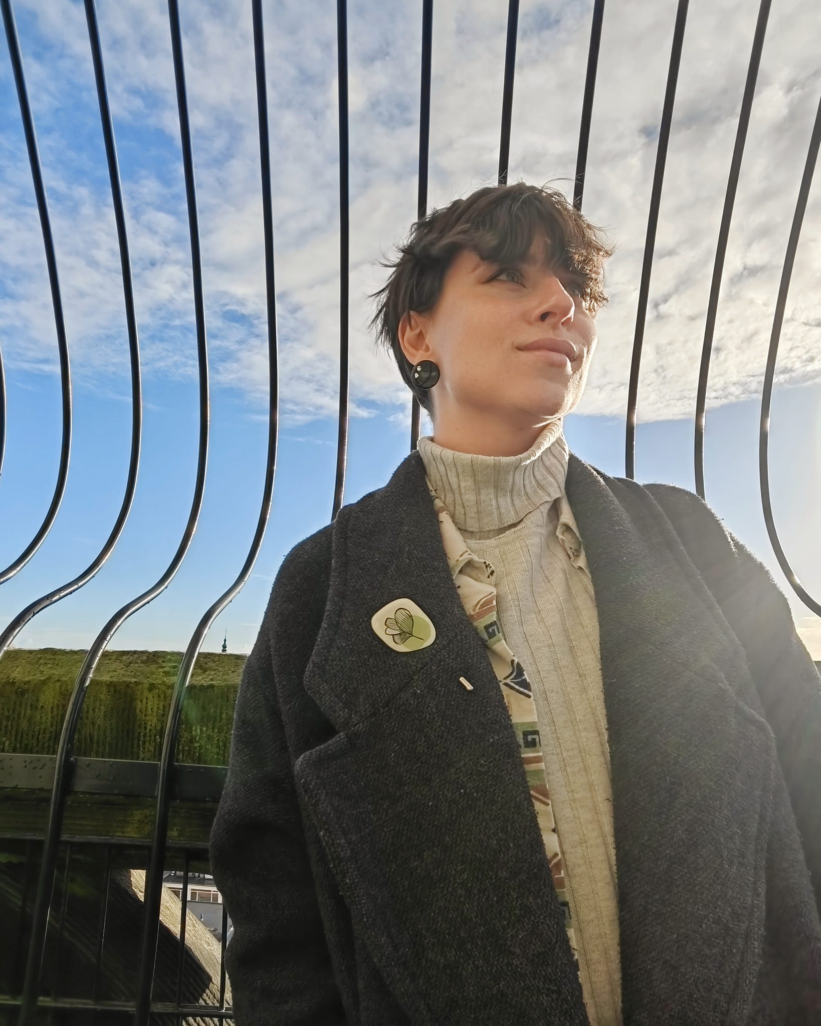 green pin on grey coat in groningen