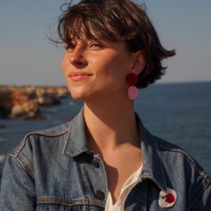pin with red flowers on a denim jacket