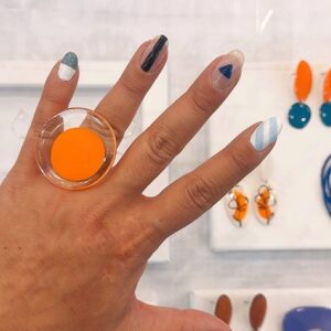 orange ring on hand at a fair
