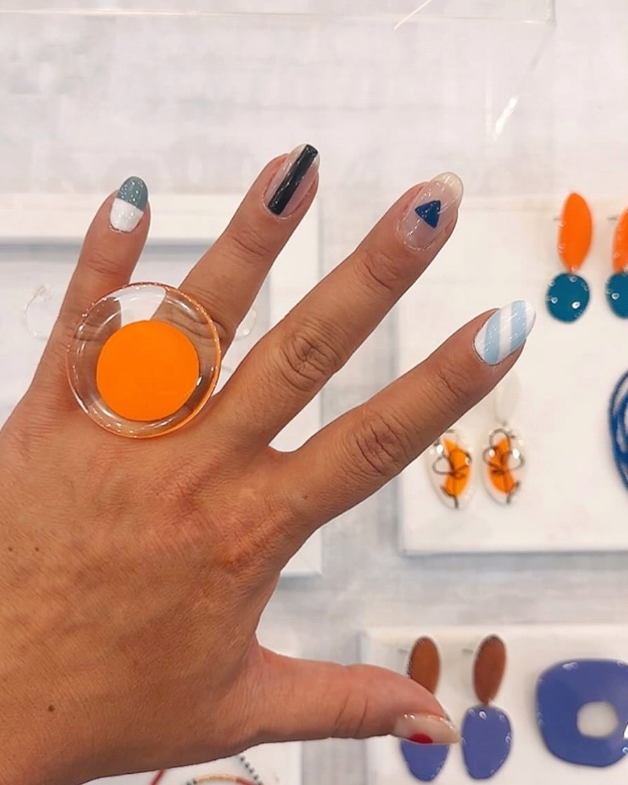 orange ring on hand at a fair