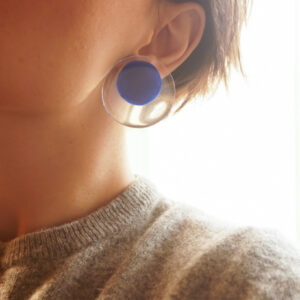 circle earrings blue on person