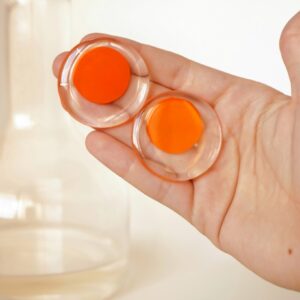 circle earrings orange in hand